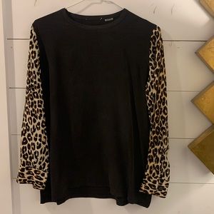 Equipment size small silk blouse, black with leopard sleeves, button cuffs.